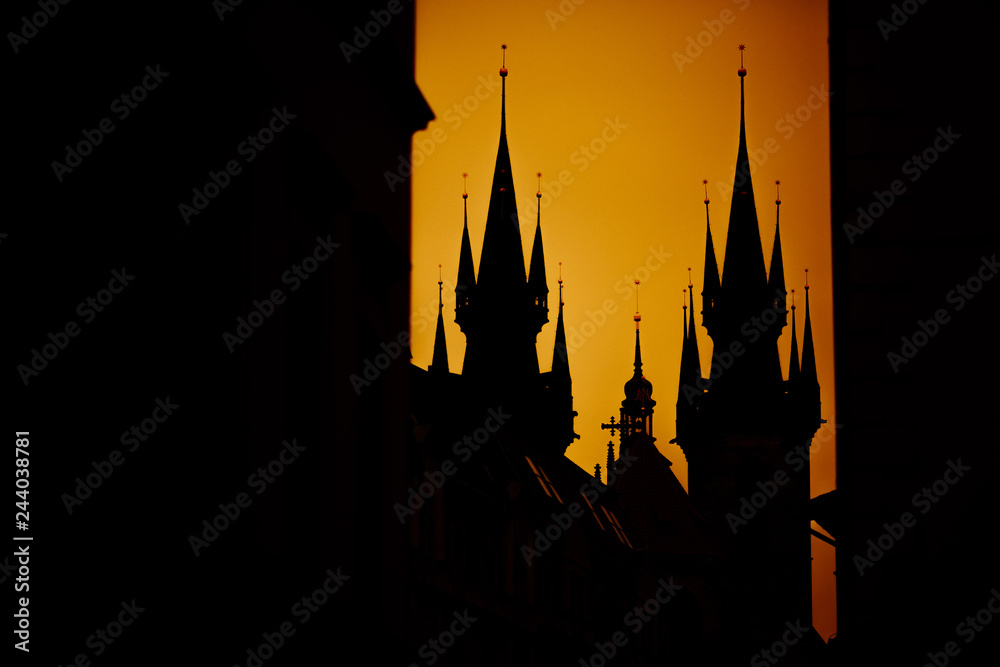  roofs of prague silhouette of the town hall and the church of Prague at sunset yellow