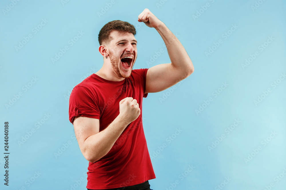 I won. Winning success happy man celebrating being a winner. Dynamic image of caucasian male model on blue studio background. Victory, delight concept. Human facial emotions concept. Trendy colors I won. Winning success happy man celebrating being a winner. Dynamic image of caucasian male model on blue studio background. Victory, delight concept. Human facial emotions concept. Trendy colors