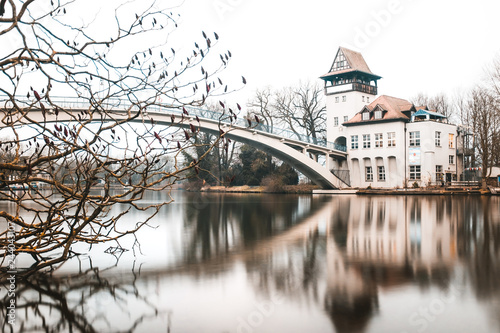 Canvas Print Scenery of the island of youth and its pedestrian bridge and tower at riverside along Spree river located in the Treptower park, during winter season in Berlin, Germany