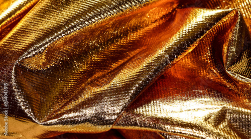 Close up view of gold coloured cloth material photo