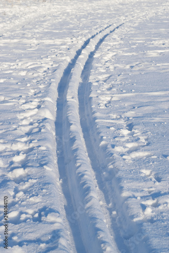 Cross-country skiing tracks in fresh snow, sunny winter day, in Finland.