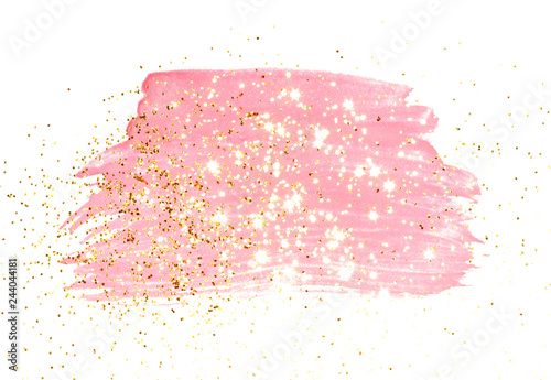 Golden glitter on abstract pink watercolor splash on white background