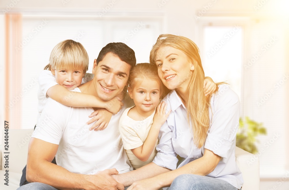 Beautiful smiling family sitting at sofa Beautiful smiling family sitting at sofa