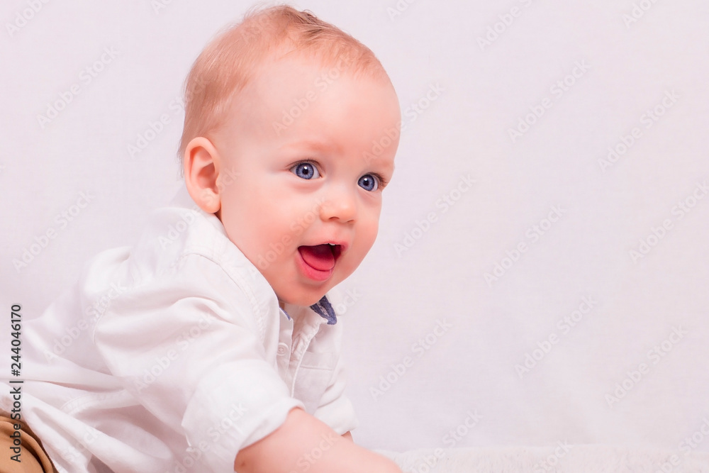 portrait of happy cute one year old baby boy against Light background portrait of happy cute one year old baby boy against Light background