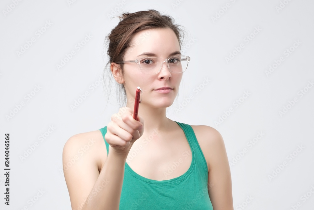 Serious european woman pointing on you with pencil. Serious european woman pointing on you with pencil.