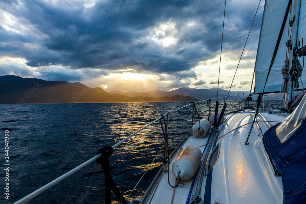 Fototapeta premium view from the yacht on the evening sunset over the sea and mountains