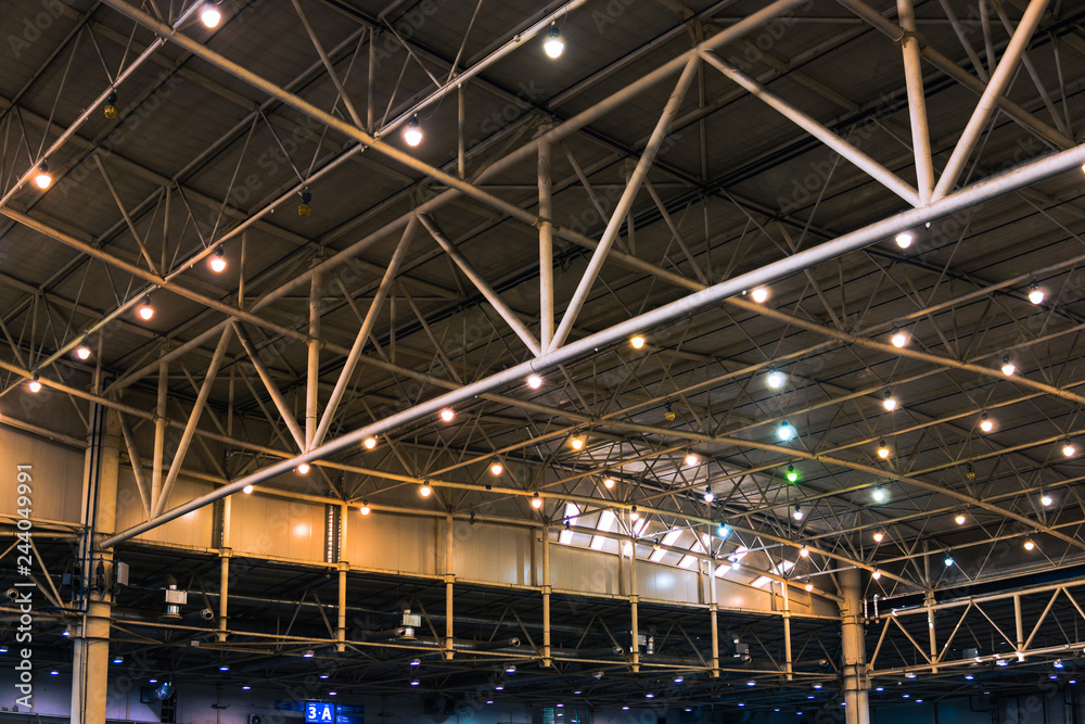 Interior of warehouse. large metal structures, ceiling. roof. concept production and installation of equipment for rooms, lighting, ventilation and windows for hangars