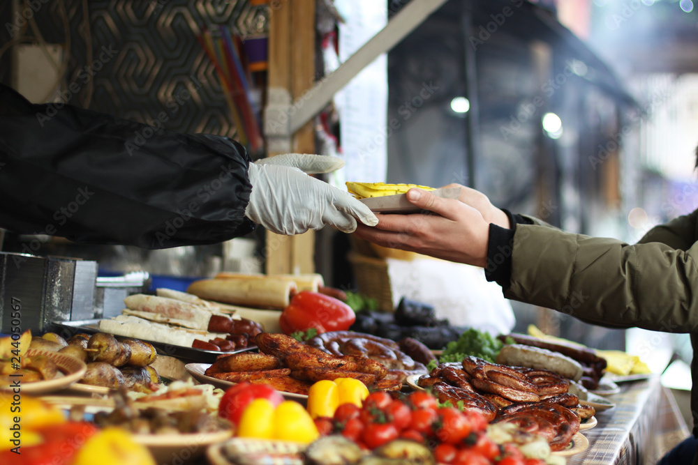 People serving street food on street market