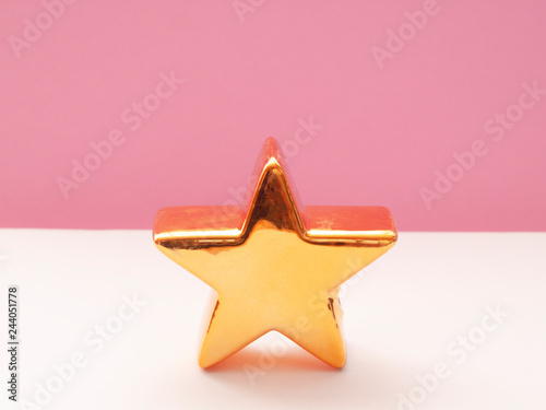 golden star on pink background