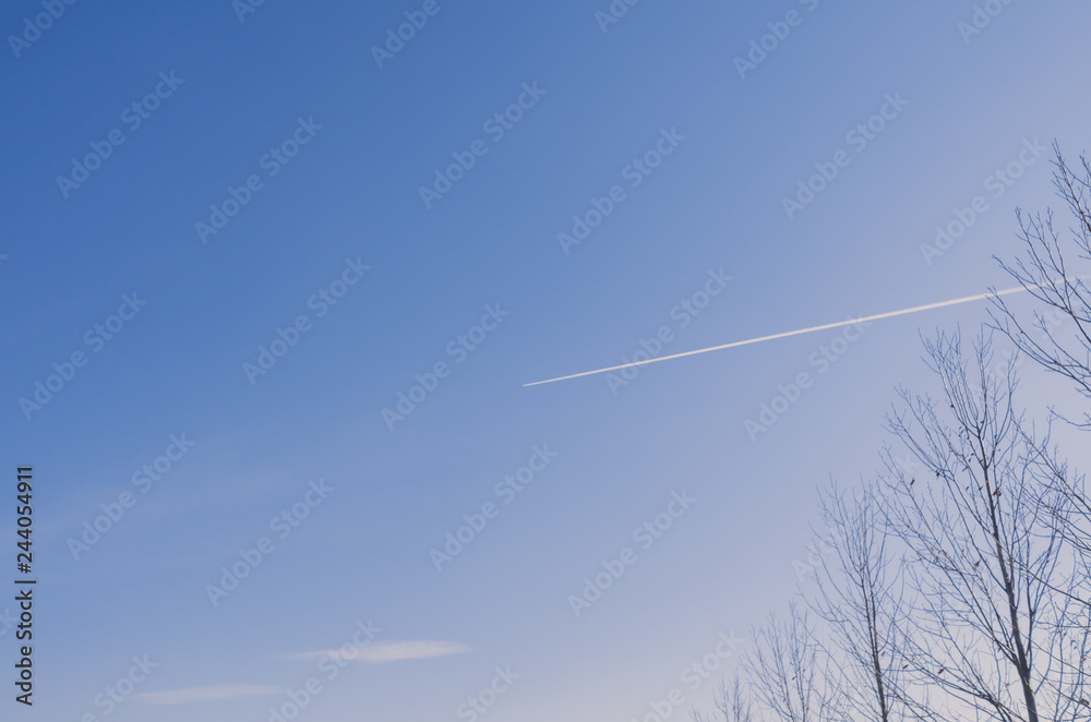 Contrails on blue sky at winter afternoon Contrails on blue sky at winter afternoon