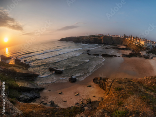 Portugal, Alentejo, Zambujeira do Mar, Praia dos Alteirinhos, rock formations at the beach in the evening photo