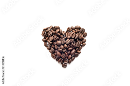 Heart shape of roasted coffee beans on white background.