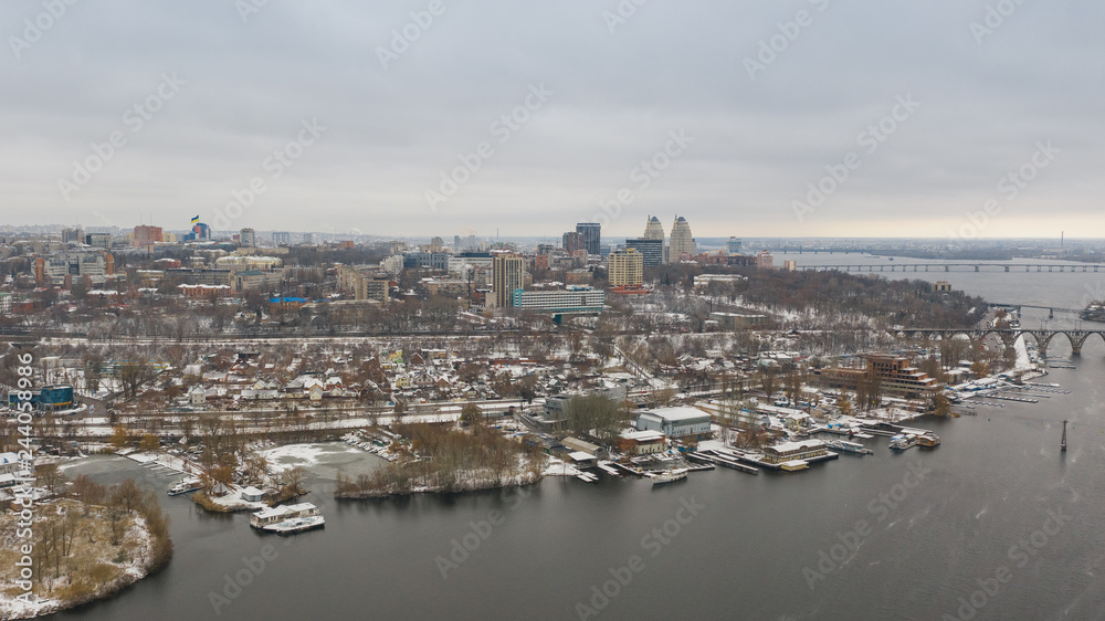 Birds eye view on cityscape, skyline and coastline of Dnieper River near Dnipro city at winter time. (Dnepr, Dnepropetrovsk, Dnipropetrovsk). Ukraine
