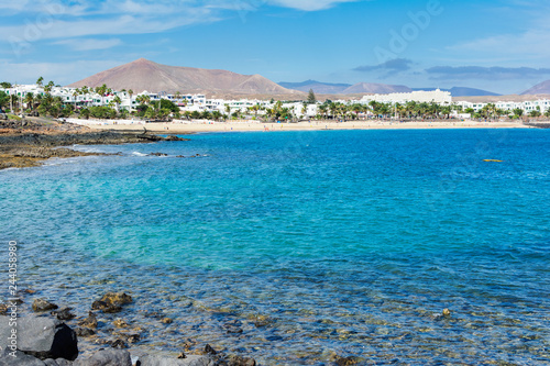 View of Playa de las Cucharas beach in Costa Teguise, Lanzarote, Spain, turquoise waters, selective focus photo