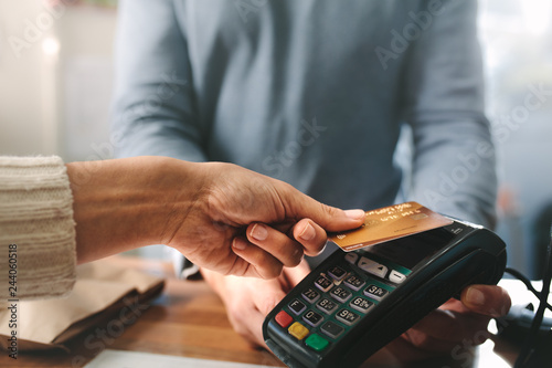 Pharmacist accepting credit card by contactless payment photo