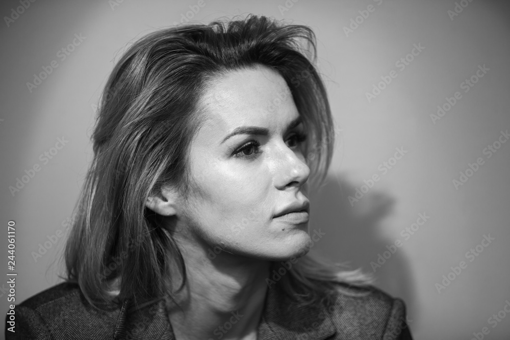Dramatic black and white portrait of a beautiful woman on a dark background
