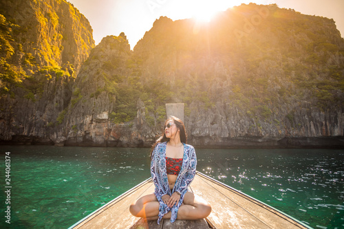 Young asian woman relax on long tail boat at Maya bay © witthaya