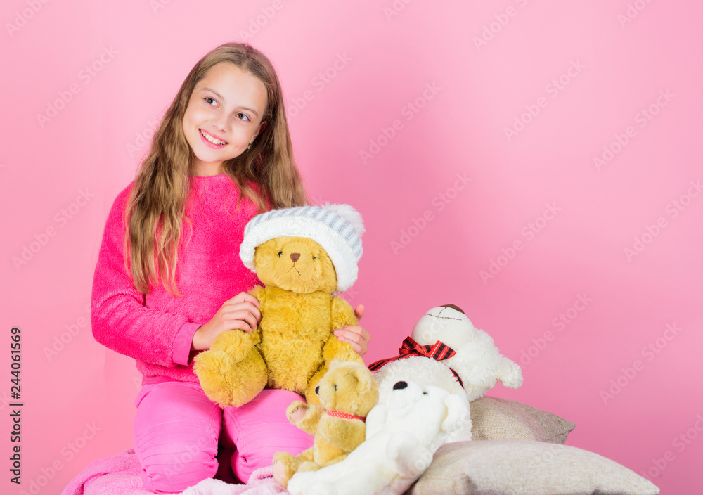 Kid little girl play with soft toy teddy bear pink background. Child small girl playful hold teddy bear plush toy. Bears toys collection. Teddy bears improve psychological wellbeing. Softness is key Kid little girl play with soft toy teddy bear pink background. Child small girl playful hold teddy bear plush toy. Bears toys collection. Teddy bears improve psychological wellbeing. Softness is key