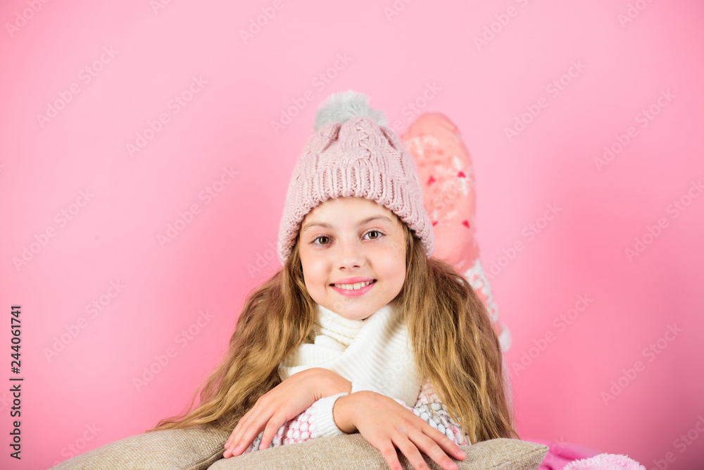 Warm accessories that will keep you cozy this winter. Kid girl wear knitted hat relaxing pink background. Child long hair warm woolen hat enjoy warm. Warm clothes concept. Keep warm and comfortable Warm accessories that will keep you cozy this winter. Kid girl wear knitted hat relaxing pink background. Child long hair warm woolen hat enjoy warm. Warm clothes concept. Keep warm and comfortable