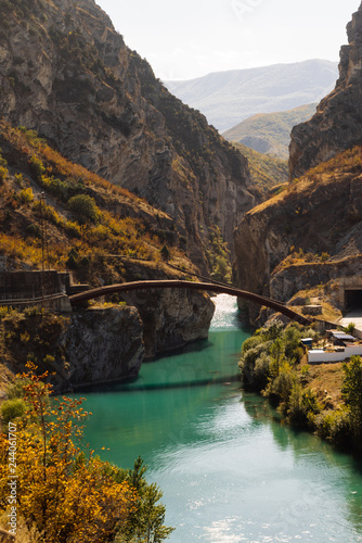 an inspiring sight, the river flows between the rocky mountains photo