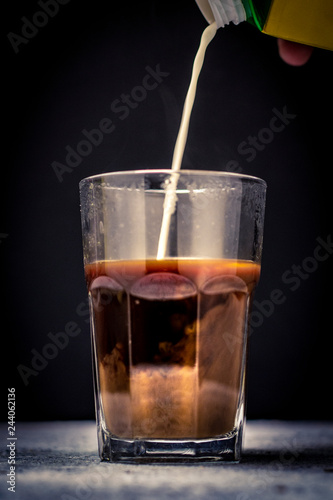 pouring coffee or milk tea into cup or glass. / splash coffee or milk tea