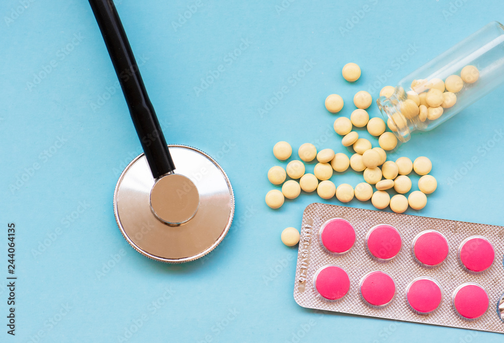 Medicine stethoscope and pills on blue background. Medicine stethoscope and pills on blue background.