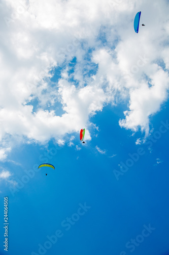 Skydiver On Colorful Parachute In Blue Sky. Active Hobbies