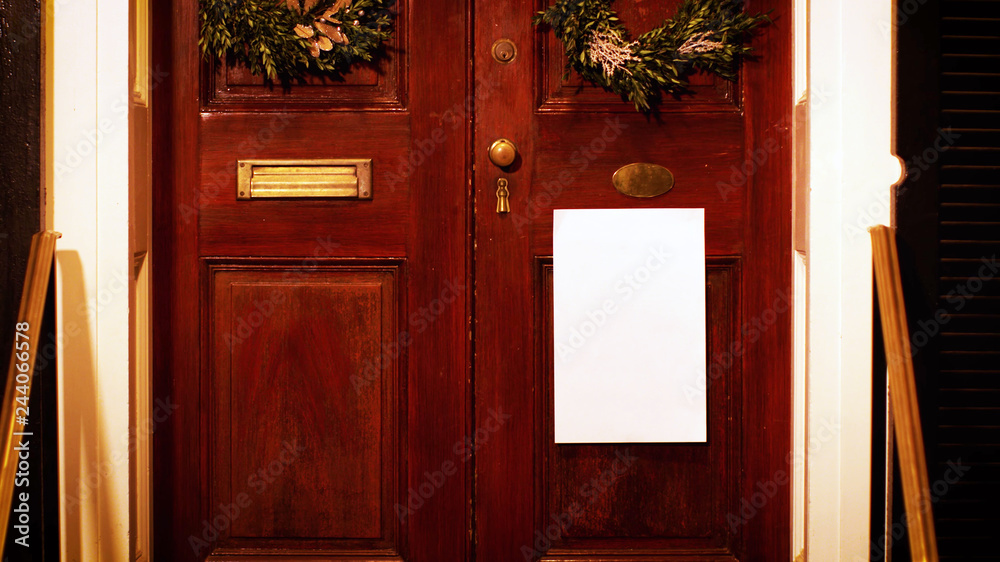 white paper poster on old wooden door with plant decoration. Mock up mockup blank frame background concept. white paper poster on old wooden door with plant decoration. Mock up mockup blank frame background concept.