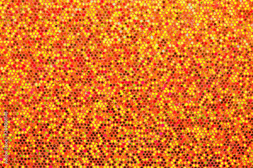Red orange background. Abstraction shiny sequins. Sequins texture closeup macro