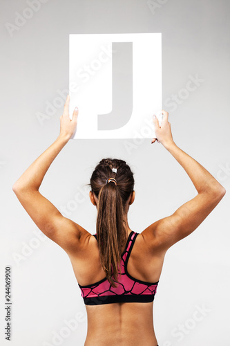 fit girl holding the letter j photo