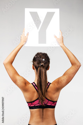 fit girl holding the letter y photo