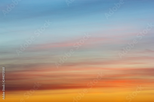 Morning sunrise. Blue sky with clouds. The morning sun illuminates the clouds.