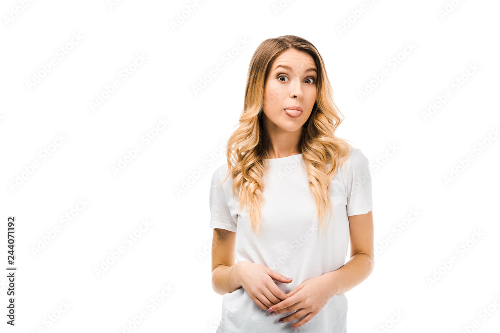 beautiful young blonde woman in white t-shirt showing tongue out and looking at camera isolated on white beautiful young blonde woman in white t-shirt showing tongue out and looking at camera isolated on white