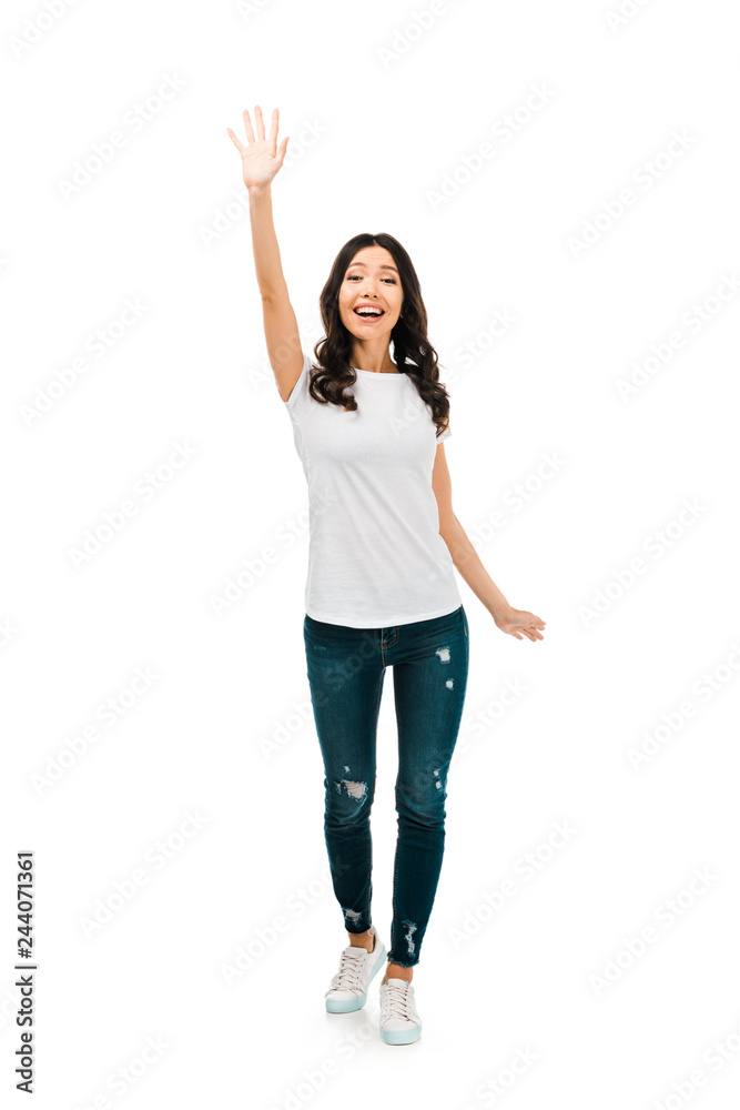 full length view of happy brunette girl waving hand isolated on white full length view of happy brunette girl waving hand isolated on white