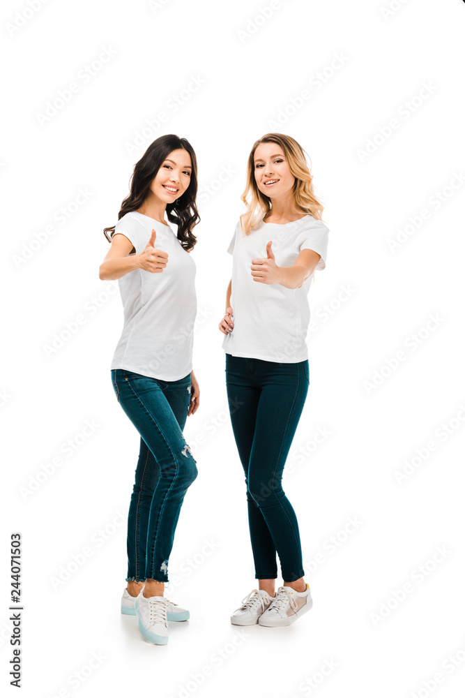 full length view of happy young women showing thumbs up and smiling at camera isolated on white full length view of happy young women showing thumbs up and smiling at camera isolated on white