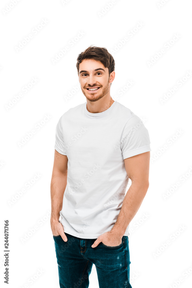 handsome happy young man standing with hands in pockets and smiling at camera isolated on white handsome happy young man standing with hands in pockets and smiling at camera isolated on white