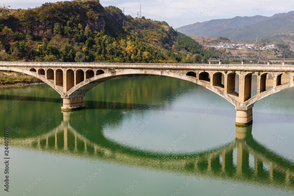 ancient stone bridge over the Bailong River, China. ancient stone bridge over the Bailong River, China.