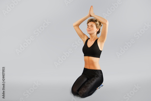 girl goes in for sports on an isolated background doing different exercises of gymnastics and fitness. The concept of a healthy lifestyle. A beautiful and slim body