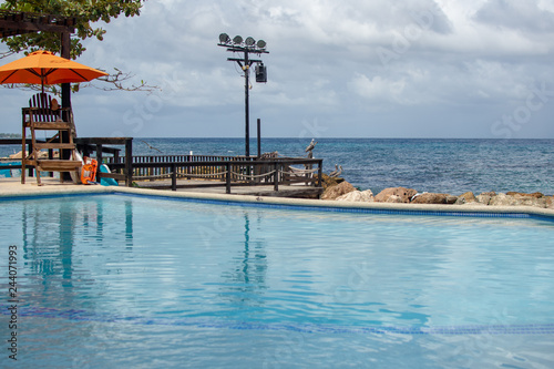 wide angle view of pool and caribbean sea from a dock