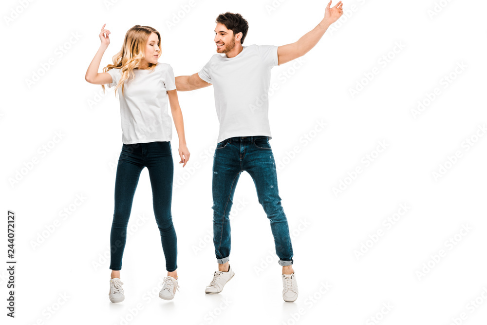 happy young couple jumping and dancing isolated on white happy young couple jumping and dancing isolated on white
