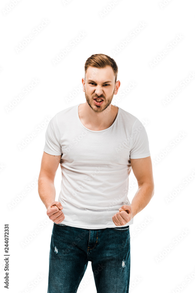 angry young man standing with clenched fists and looking at camera isolated on white angry young man standing with clenched fists and looking at camera isolated on white