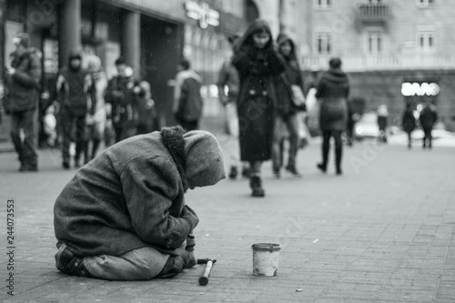 Elderly beggar woman on the street asking for money. Beggars. Social problem. Black and white. Social issue