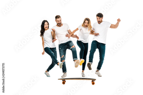 happy young friends having fun with skateboard isolated on white