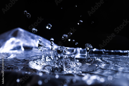 Water drops splashing on acoustic membrane. A lot of drops in air. High frequency of sound waves. Water cloud small drops. Frozen time shot. © Alexs