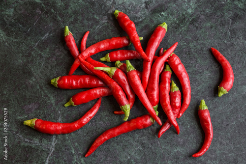 Red hot peppers on dark stone background