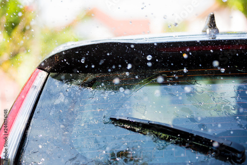 The wiper on rear window of a car with drop rain
