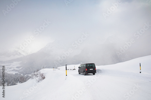 Van driving along snowcapped mountain road © Miriam