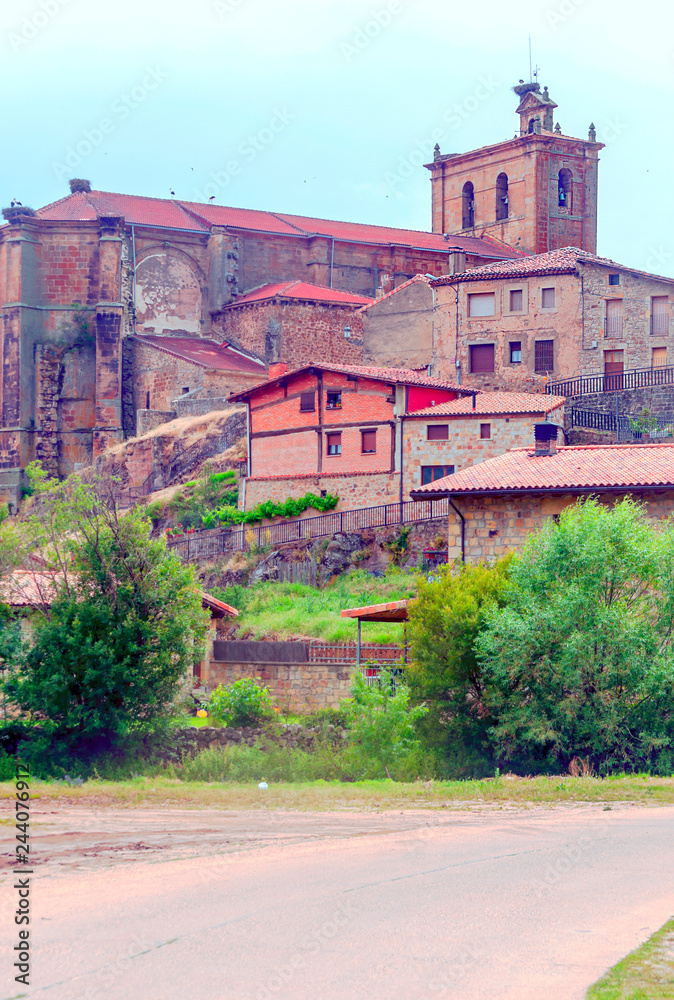 Vinuesa with its Romanesque church on a sunny day. It is a town in the province of Soria in Spain.