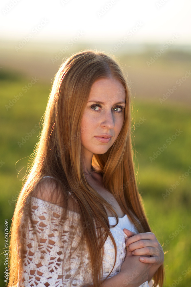 Portrait of a beautiful girl with red hair holding a white knitted scarf. Closeup portrait Portrait of a beautiful girl with red hair holding a white knitted scarf. Closeup portrait