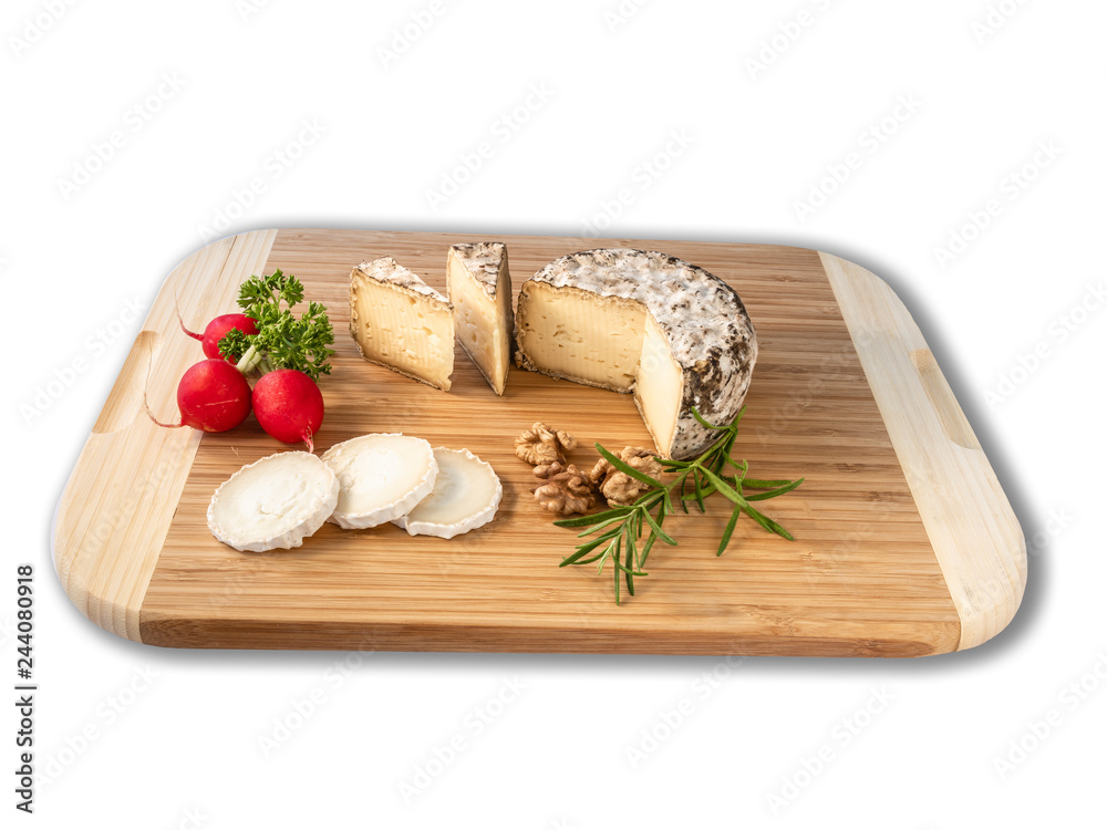 Cheese from France named Tommette des Alpes and white round goat cheese with nuts and parsley on the black background with shadow Cheese from France named Tommette des Alpes and white round goat cheese with nuts and parsley on the black background with shadow